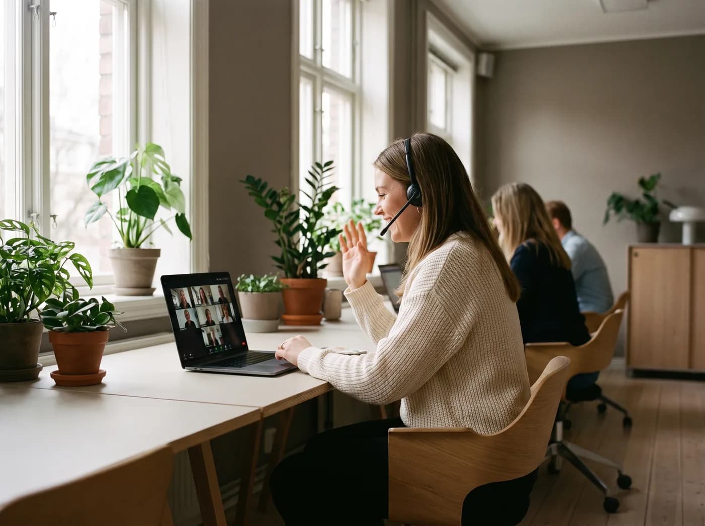 A support team member waving at the start of a video call